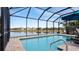 Enclosed pool and patio area with lake view at 287 Cassano Dr, Nokomis, FL 34275