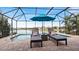 Relaxing pool area with lounge chairs and lake view at 287 Cassano Dr, Nokomis, FL 34275