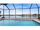 Inviting pool with screened enclosure and scenic lake view at 287 Cassano Dr, Nokomis, FL 34275