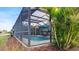 Screened pool and patio with lush landscaping and seating at 287 Cassano Dr, Nokomis, FL 34275
