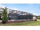 Relaxing screened pool and patio area with lush landscaping at 287 Cassano Dr, Nokomis, FL 34275