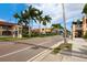 View of a street with shops and palm trees at 287 Cassano Dr, Nokomis, FL 34275