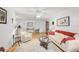 Living room with hardwood floors, white couch, and a ceiling fan at 4160 Fruitville Rd # 14, Sarasota, FL 34232