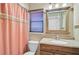 Bathroom with updated vanity and coral shower curtain at 510 Pendleton Pl, Venice, FL 34292