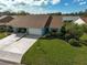 Two-car garage, attractive landscaping, and curb appeal at 510 Pendleton Pl, Venice, FL 34292