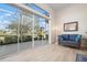 Sunroom with wicker couch and view of the golf course at 515 Governors Green Dr, Venice, FL 34293