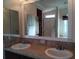 Double vanity bathroom with large mirror and shower at 657 N Green Cir, Venice, FL 34285
