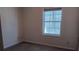 Small bedroom with carpeted floor and window at 657 N Green Cir, Venice, FL 34285