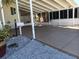 Covered carport with concrete slab and gravel at 657 N Green Cir, Venice, FL 34285