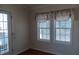 Sunroom features two windows with window treatments at 657 N Green Cir, Venice, FL 34285