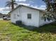 Exterior view of a single-story home with white siding and a grassy yard at 704 Chippy Ln, Nokomis, FL 34275