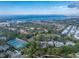 Aerial view of community, tennis courts, and water at 752 Pine Run Dr, Osprey, FL 34229