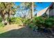 Large backyard with tropical plants and partial shade at 752 Pine Run Dr, Osprey, FL 34229