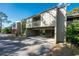 Two-story condo building with carport parking and lush landscaping at 752 Pine Run Dr, Osprey, FL 34229