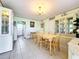 Dining room with light wood table and chairs, and china cabinets at 8333 Herbison Ave, North Port, FL 34287