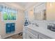 Bathroom featuring a white vanity with plenty of storage, designer mirror, and subway tile backsplash at 922 Casey Cove Dr, Nokomis, FL 34275