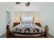 Main bedroom with a wooden bed frame and ensuite bathroom at 922 Casey Cove Dr, Nokomis, FL 34275