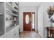 Foyer featuring hardwood floors, stained glass front door and built in shelving for storage at 922 Casey Cove Dr, Nokomis, FL 34275