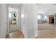 Hallway view into bedroom and Gathering room with wood and carpet flooring at 922 Casey Cove Dr, Nokomis, FL 34275