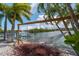 Peaceful waterfront hammock for relaxation at 922 Casey Cove Dr, Nokomis, FL 34275