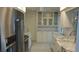 Modern kitchen featuring stainless steel appliances, subway tile, and white cabinetry at 922 Casey Cove Dr, Nokomis, FL 34275
