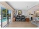 Living area with gray couches and views of pool and canal at 922 Casey Cove Dr, Nokomis, FL 34275