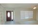 Bright living room featuring a front door, large window, and built-in shelving at 922 Casey Cove Dr, Nokomis, FL 34275