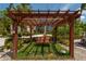 Charming pergola with a wooden swing at 922 Casey Cove Dr, Nokomis, FL 34275