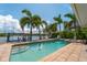 Inviting pool area with canal views and lush landscaping at 922 Casey Cove Dr, Nokomis, FL 34275