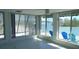 Enclosed sunroom boasting large windows overlooking the waterfront at 922 Casey Cove Dr, Nokomis, FL 34275