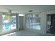 Bright sunroom with view of pool and waterfront with access to boat dock at 922 Casey Cove Dr, Nokomis, FL 34275
