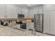 Well-lit kitchen featuring stainless steel appliances, granite countertops, and white cabinetry at 9855 Haze Dr, Venice, FL 34292