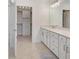 Well-lit bathroom featuring a large vanity, drawers and an accessible walk-in closet at 10055 Crooked Creek Dr # 102, Venice, FL 34293