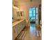 Bright bathroom featuring a spacious vanity, tiled floor, and glass-enclosed shower at 10055 Crooked Creek Dr # 102, Venice, FL 34293