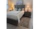 Comfortable bedroom with wood-look floors, neutral walls, and coastal-themed decor at 10055 Crooked Creek Dr # 102, Venice, FL 34293