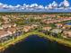 Panoramic aerial view of the home and neighborhood, surrounded by scenic ponds and lush landscaping at 11679 Anhinga Ave, Venice, FL 34292