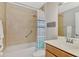 Bathroom with tub shower combination and wood vanity at 11679 Anhinga Ave, Venice, FL 34292