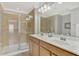 Double vanity bathroom with walk in shower and large mirror at 11679 Anhinga Ave, Venice, FL 34292