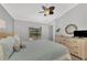 Serene bedroom with light blue bedding and wood dresser at 11679 Anhinga Ave, Venice, FL 34292