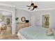 Spacious bedroom with light blue bedding and access to another room at 11679 Anhinga Ave, Venice, FL 34292