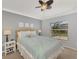 Bright bedroom with a light blue comforter and wicker headboard at 11679 Anhinga Ave, Venice, FL 34292