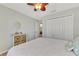 Bedroom with white bedding, dresser, and large closet at 11679 Anhinga Ave, Venice, FL 34292
