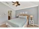 Cozy bedroom with a light blue comforter and wicker headboard at 11679 Anhinga Ave, Venice, FL 34292