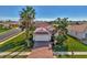 Beautifully landscaped home featuring a well-maintained lawn, mature palms, and a brick-paved driveway at 11679 Anhinga Ave, Venice, FL 34292