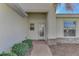 Charming front entrance with decorative glass door, brick walkway and manicured landscaping at 11679 Anhinga Ave, Venice, FL 34292