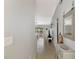 Inviting hallway with neutral walls, tile flooring, and stylish decor leads to living spaces at 11679 Anhinga Ave, Venice, FL 34292