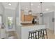 Open concept kitchen with breakfast bar, granite countertops, stainless steel appliances and pendant lighting at 11679 Anhinga Ave, Venice, FL 34292