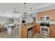 Modern kitchen with stainless steel appliances, granite countertops and open view to the living area at 11679 Anhinga Ave, Venice, FL 34292