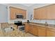 A well-equipped kitchen featuring stainless steel appliances, granite countertops, and ample cabinetry at 11679 Anhinga Ave, Venice, FL 34292