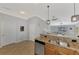 Modern kitchen with granite countertops, stainless steel appliances, open layout to Gathering room at 11679 Anhinga Ave, Venice, FL 34292